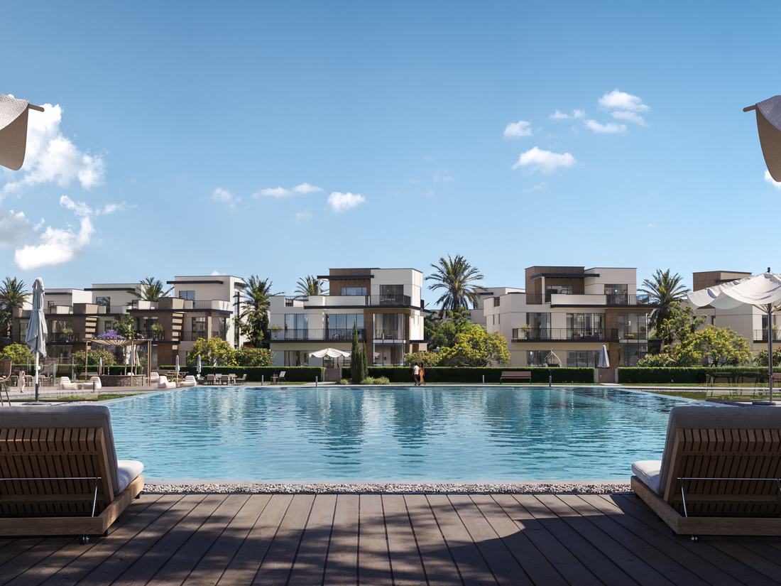 Community swimming pool framed by residences and palms